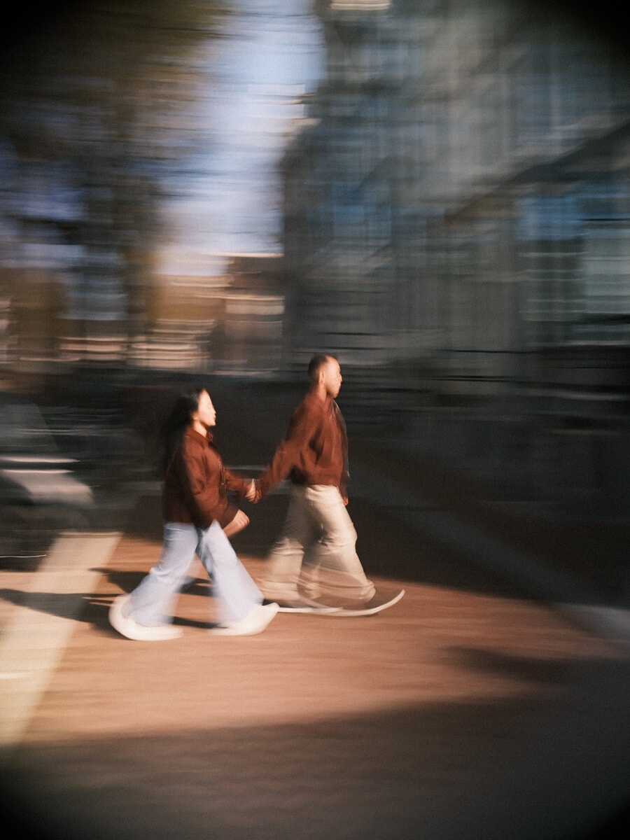 Engagement SP7 Atmospheric motion-blur engagement photo of a couple walking hand in hand through Amsterdam
