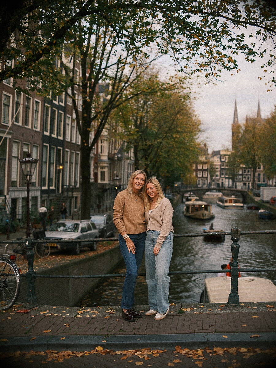 Family SP9 Mother and teenage daughter leaning together for a portrait on an Amsterdam canal bridge in autumn