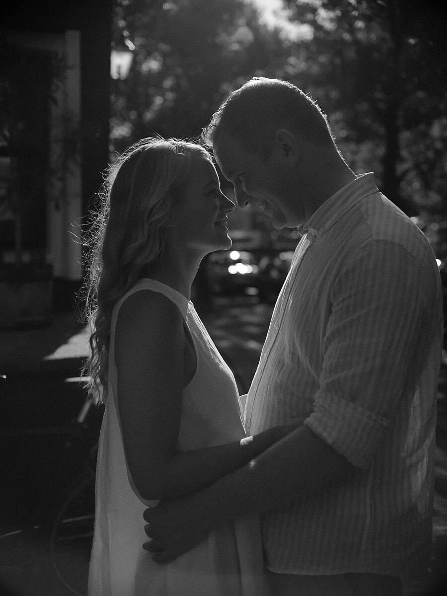 Couple forehead to forehead in backlight, romantic couple photography in black and white