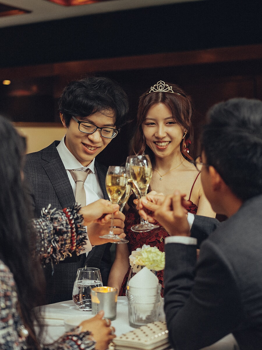 Wedding Ceremony SP25 Raising champagne with guests at a candlelit reception, the bride in a tiara toasts before a wedding photographer in Amsterdam