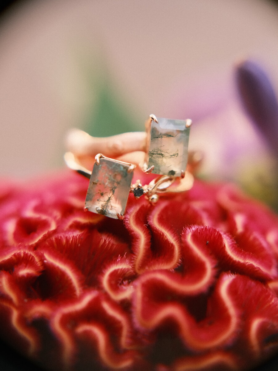 Wedding Bridal SP15 Close-up of two gold rings set with moss agate resting on a deep red celosia bloom, a fine detail from the bridal photo session