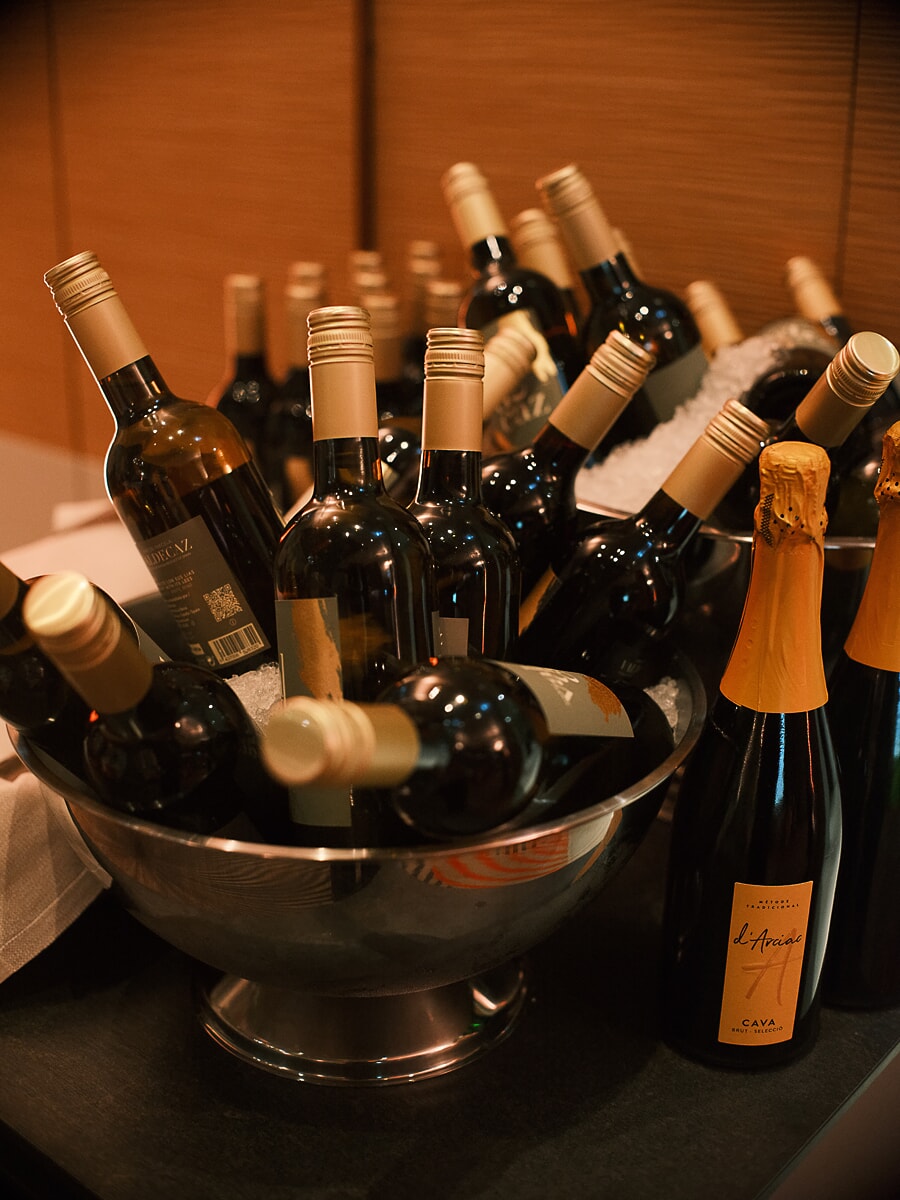 Wine and cava bottles standing in silver ice bowls at the bar